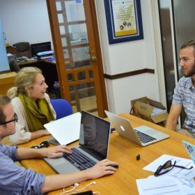 A group of Human Rights interns in Africa have a lively discussion while doing research for a case. 